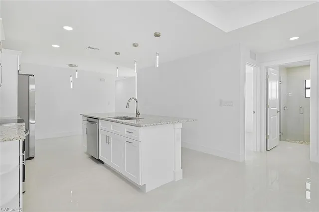 a bathroom with a double vanity sink a mirror and shower