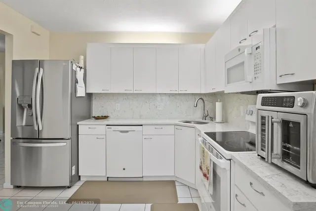 a kitchen with cabinets appliances and a counter space