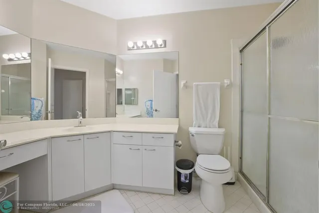 a spacious bathroom with a sink a toilet and a large mirror
