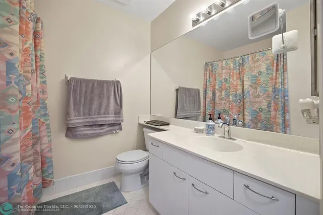 an aerial view of residential houses with outdoor space and lake view