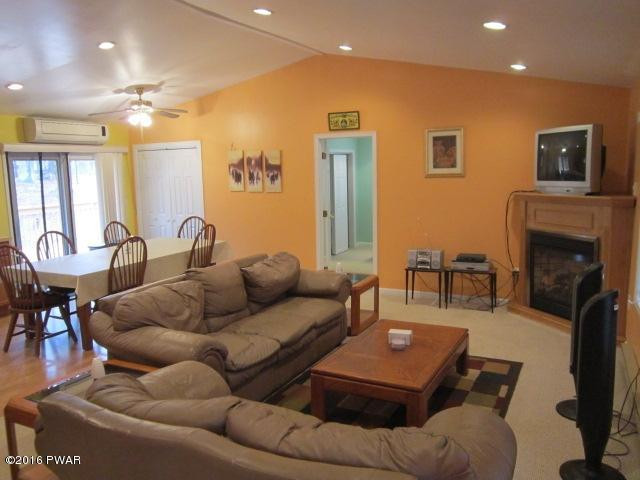 203 Westcolang Road Lackawaxen, PA 18435 - Photo 5 of 15 a living room with furniture and a fireplace