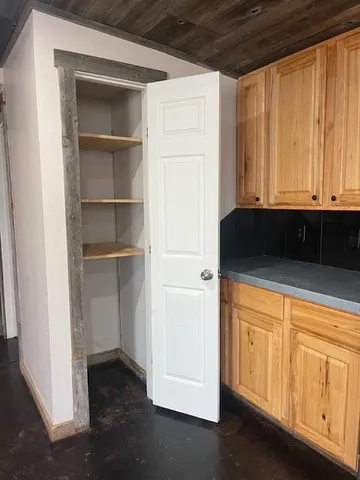 a view of a closet with wooden floor