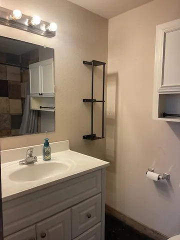 a bathroom with a sink a vanity and mirror
