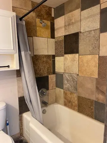 a bathroom with a bathtub and a shower