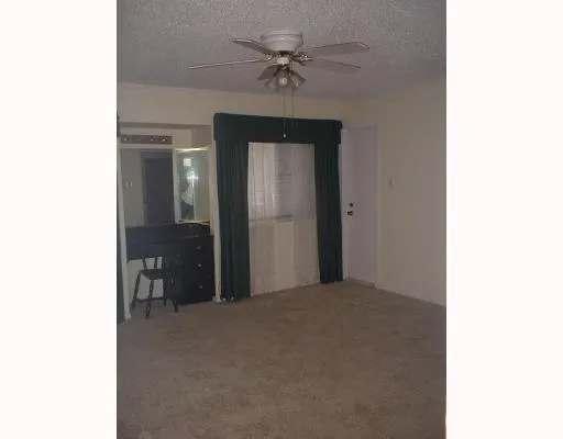 a view of a room with a ceiling fan