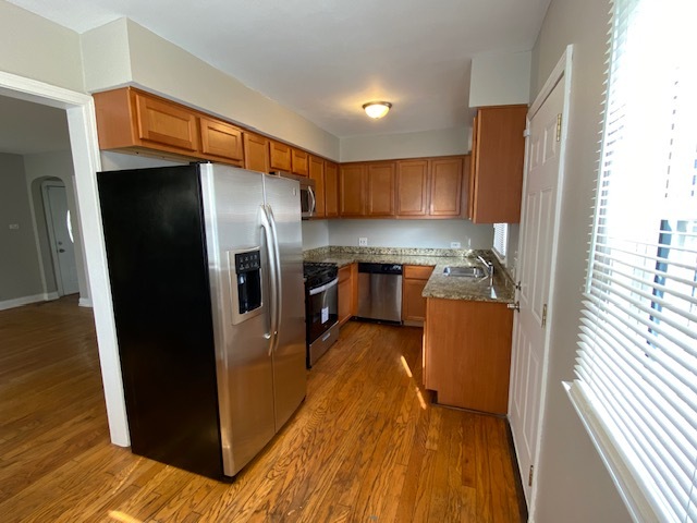 17843 Roy Street Lansing, IL 60438 - Photo 3 of 19 a kitchen with stainless steel appliances granite countertop a refrigerator a stove and a sink