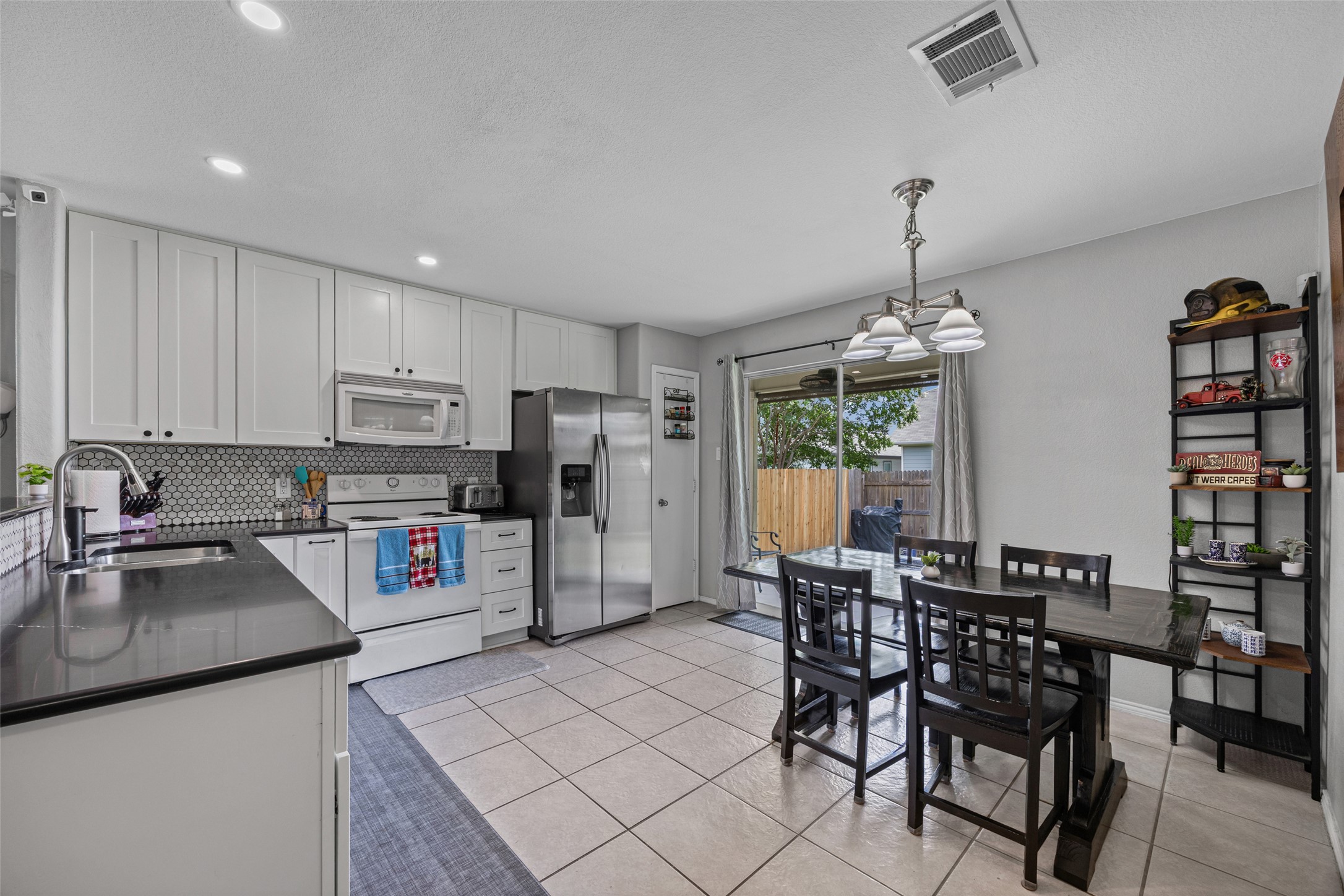 13501 Lismore Lane Pflugerville, TX 78660 - Photo 8 of 28 Custom backsplash adds a pretty feature to this kitchen