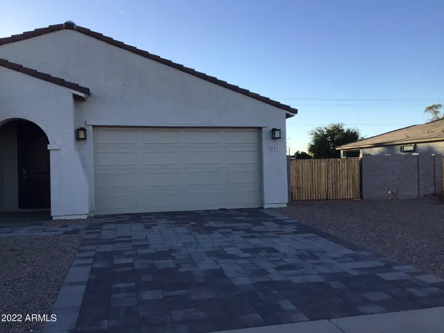 a backyard of house with garage