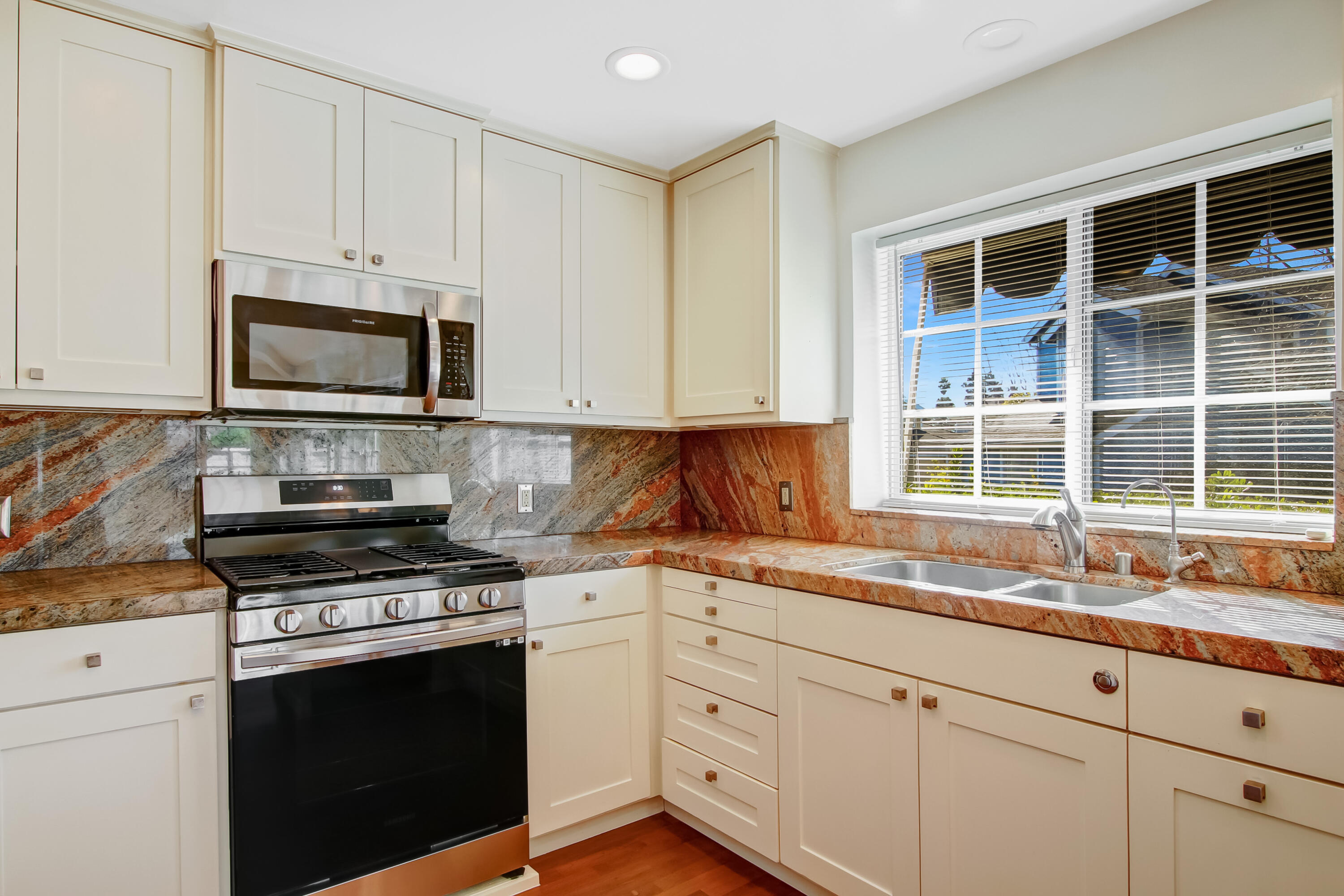 1541 Meadow Circle Carpinteria, CA 93013 - Photo 23 of 36 a kitchen with granite countertop a stove a sink and dishwasher wooden cabinets with granite countertops