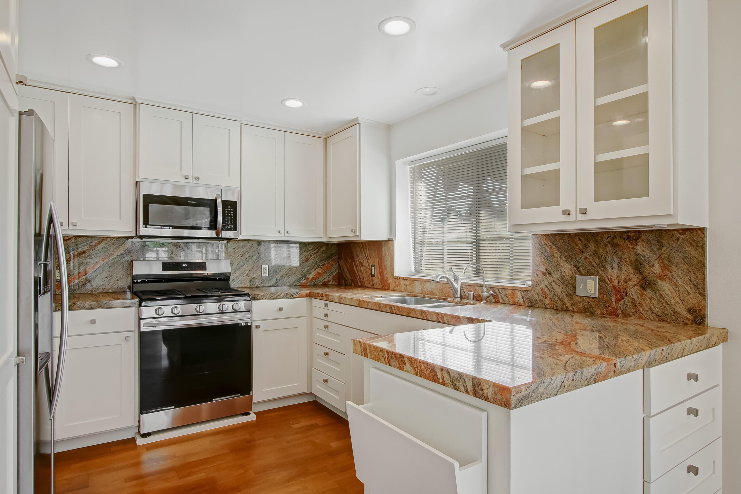 1541 Meadow Circle Carpinteria, CA 93013 - Photo 24 of 36 a kitchen with granite countertop a stove sink and microwave