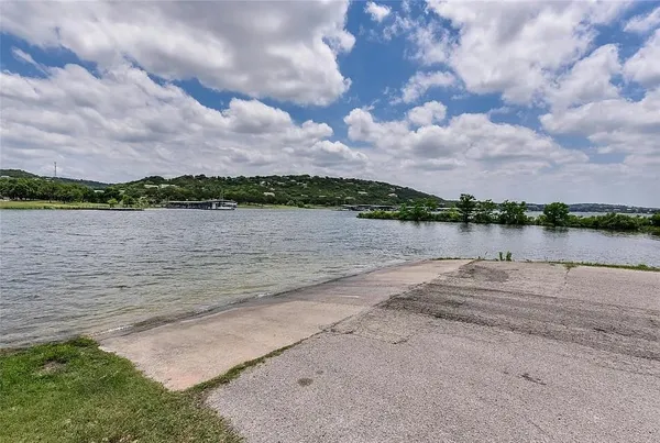 a view of a lake with houses in the back