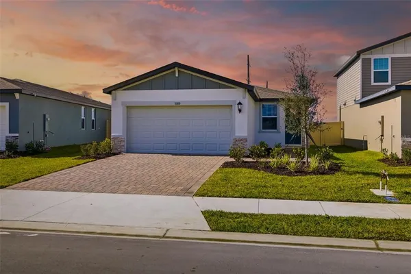 a front view of a house with a yard and garage