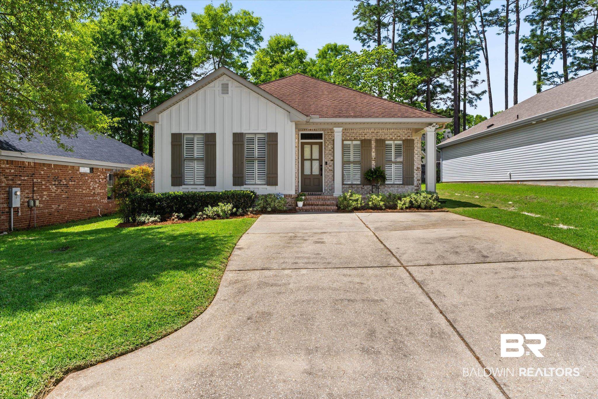 1052 Linlen Avenue Mobile, AL 36609 - Photo 1 of 22 View of front of property with brick siding, board and batten siding, a porch, a front yard, and a shingled roof