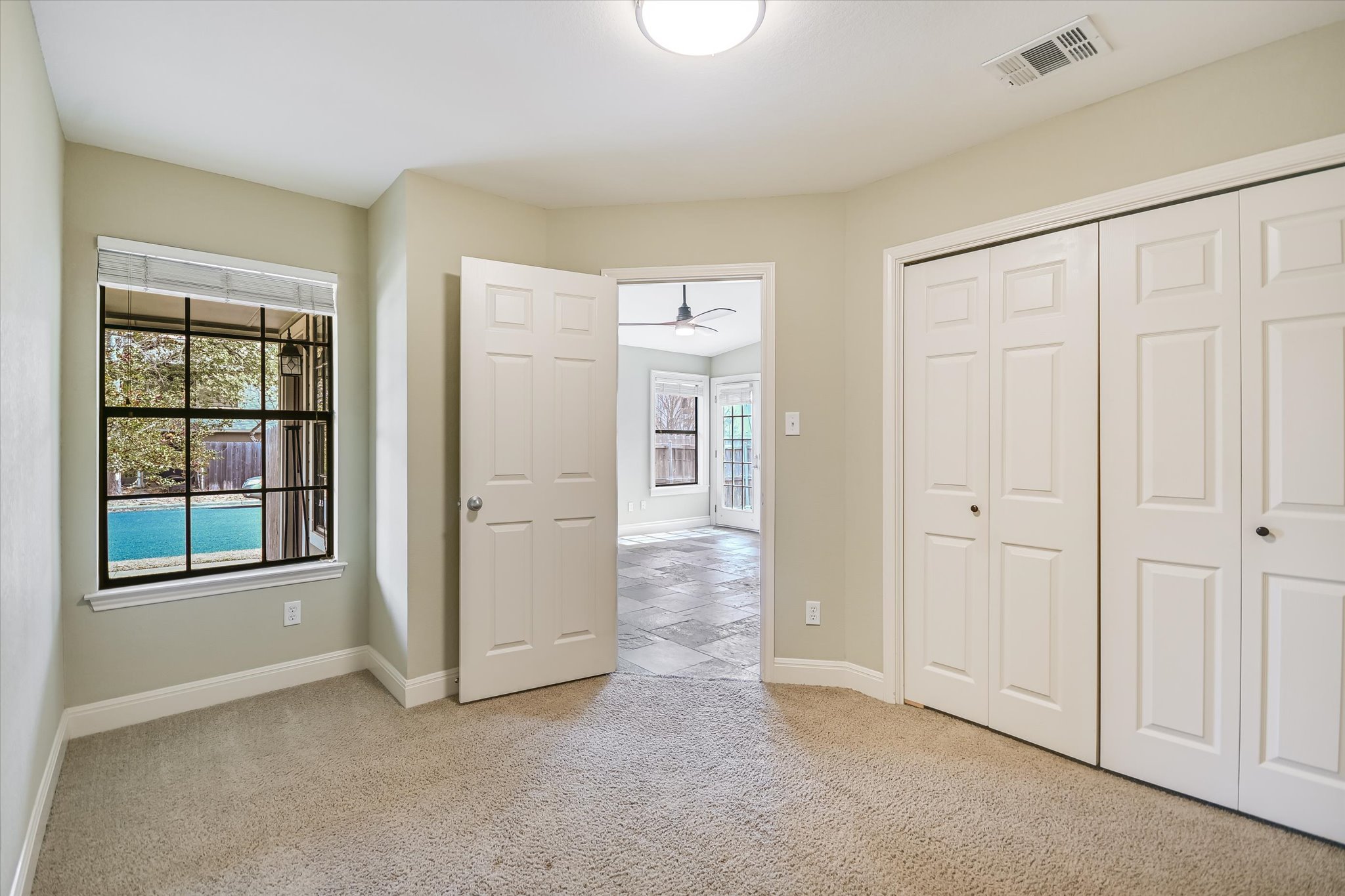 7701 Grovedale Trail Austin, TX 78729 - Photo 11 of 13 Unfurnished bedroom with light carpet and a closet