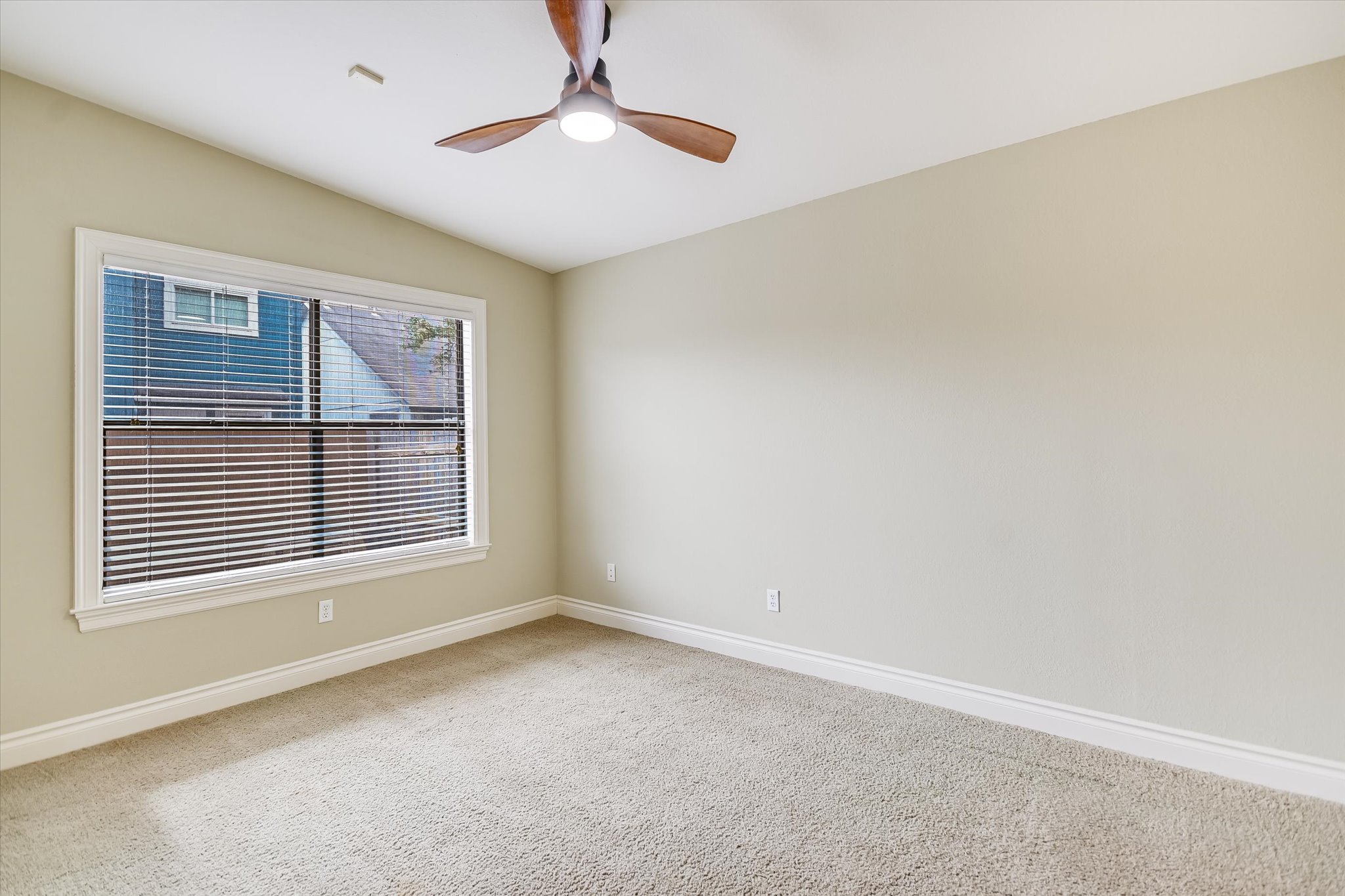 7701 Grovedale Trail Austin, TX 78729 - Photo 7 of 13 Carpeted spare room with vaulted ceiling and ceiling fan