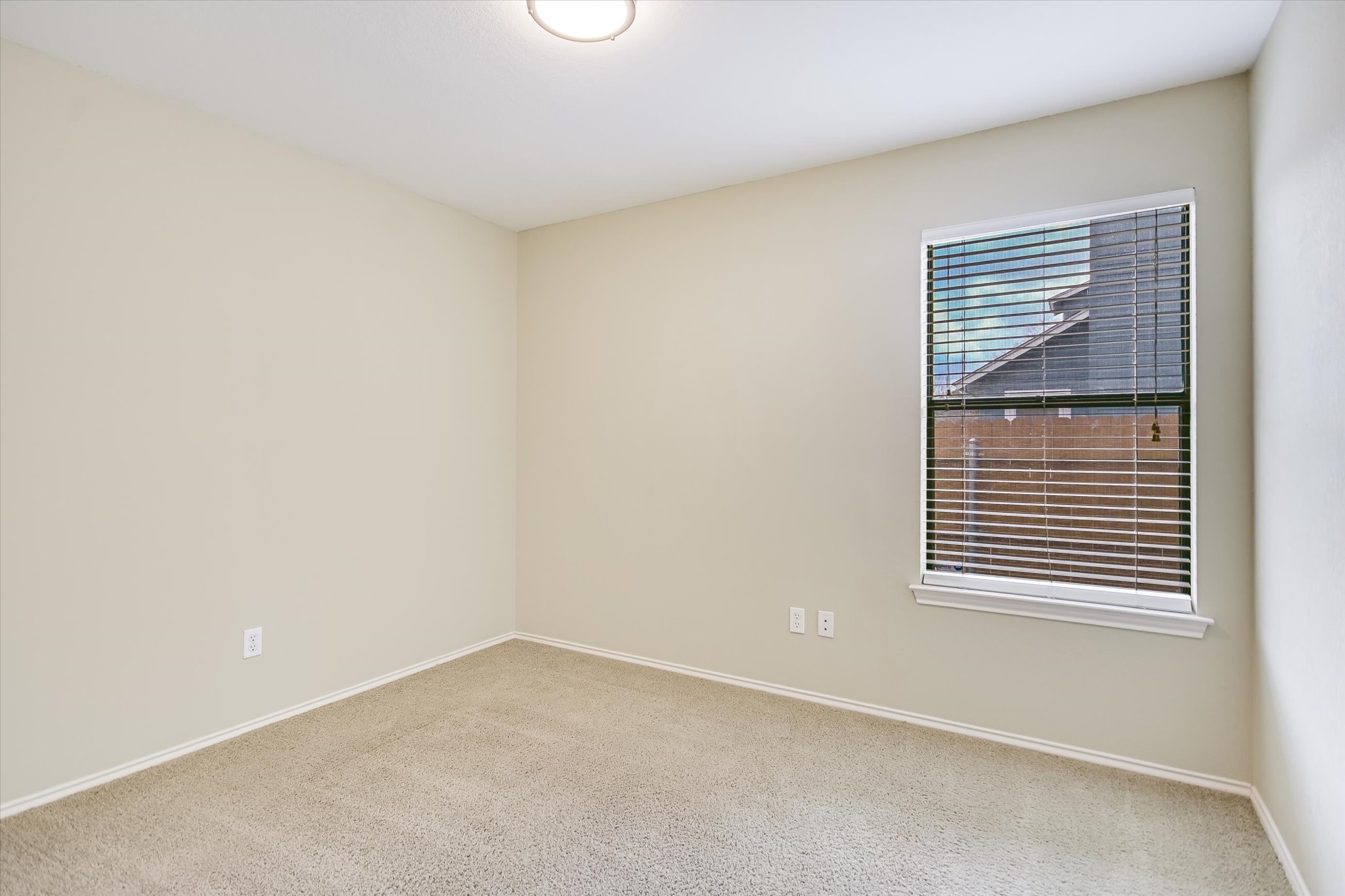 7701 Grovedale Trail Austin, TX 78729 - Photo 9 of 13 Spare room with carpet floors and baseboards