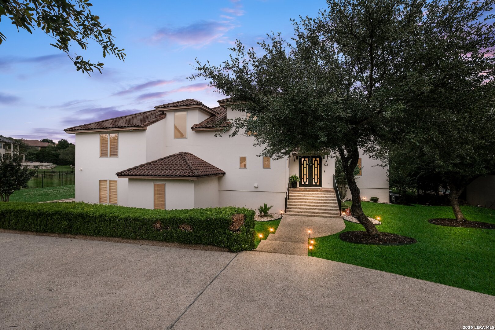 426 Legacy Ridge San Antonio, TX 78258 - Photo 3 of 38 a front view of a house with garden