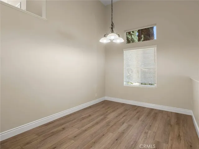 a view of a room with wooden floor and windows