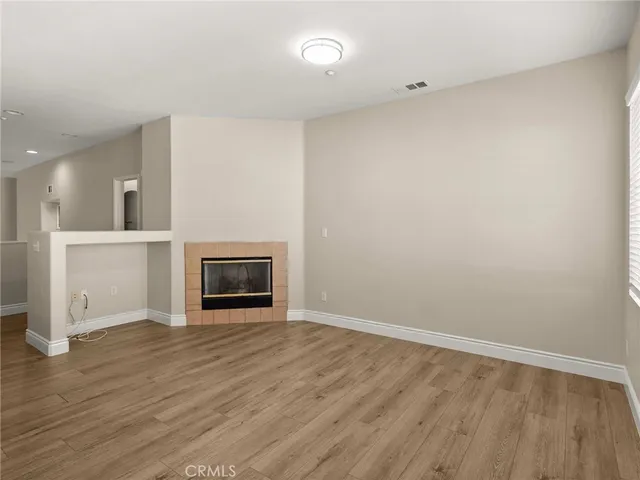 wooden floor in an empty room with a fireplace