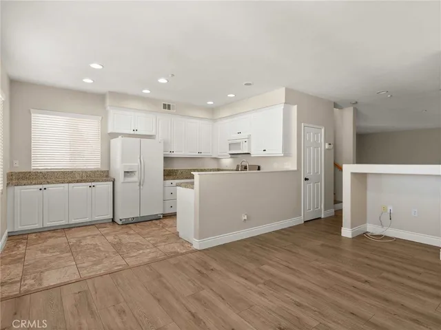 a kitchen with stainless steel appliances a refrigerator sink and cabinets