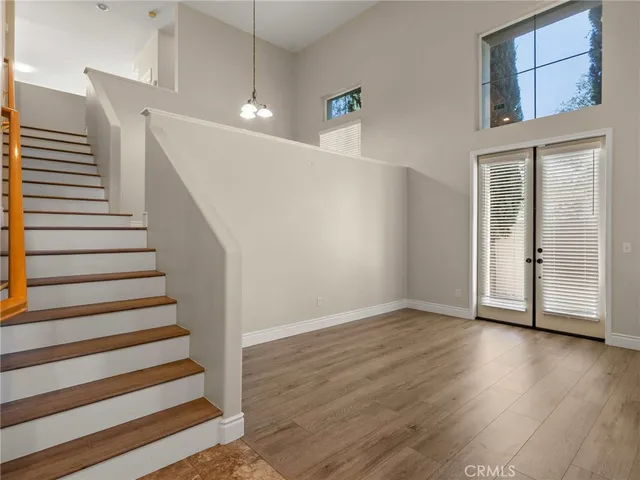 a view of an entryway with wooden floor