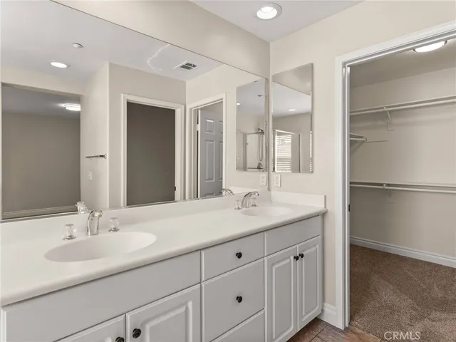 a bathroom with a sink double vanity and a mirror