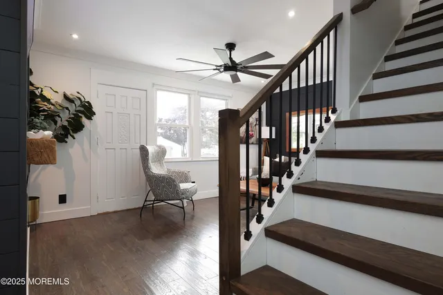a view of entryway and hall with wooden floor