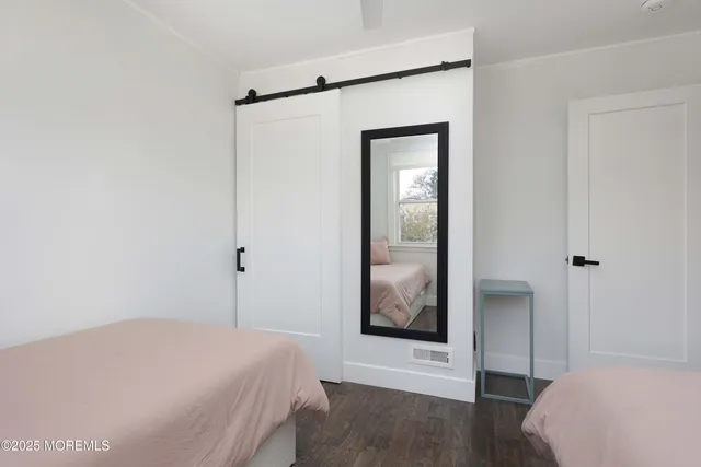 a bedroom with a bed and a mirror