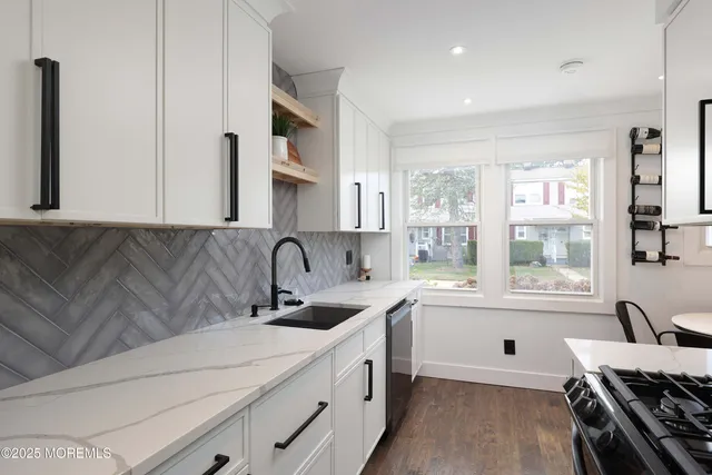 a kitchen with a sink stove and cabinets