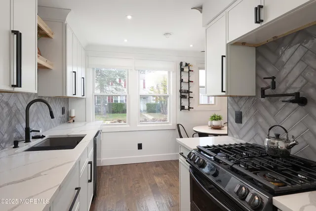 a kitchen with granite countertop a stove and a sink