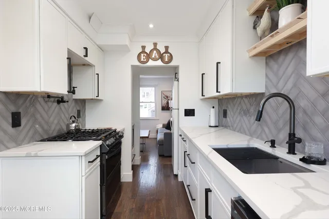 a kitchen with a sink stove and cabinets