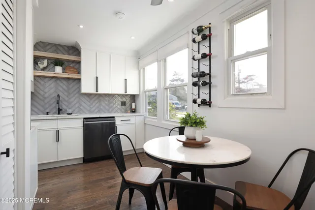 a kitchen with a table chairs sink and cabinets