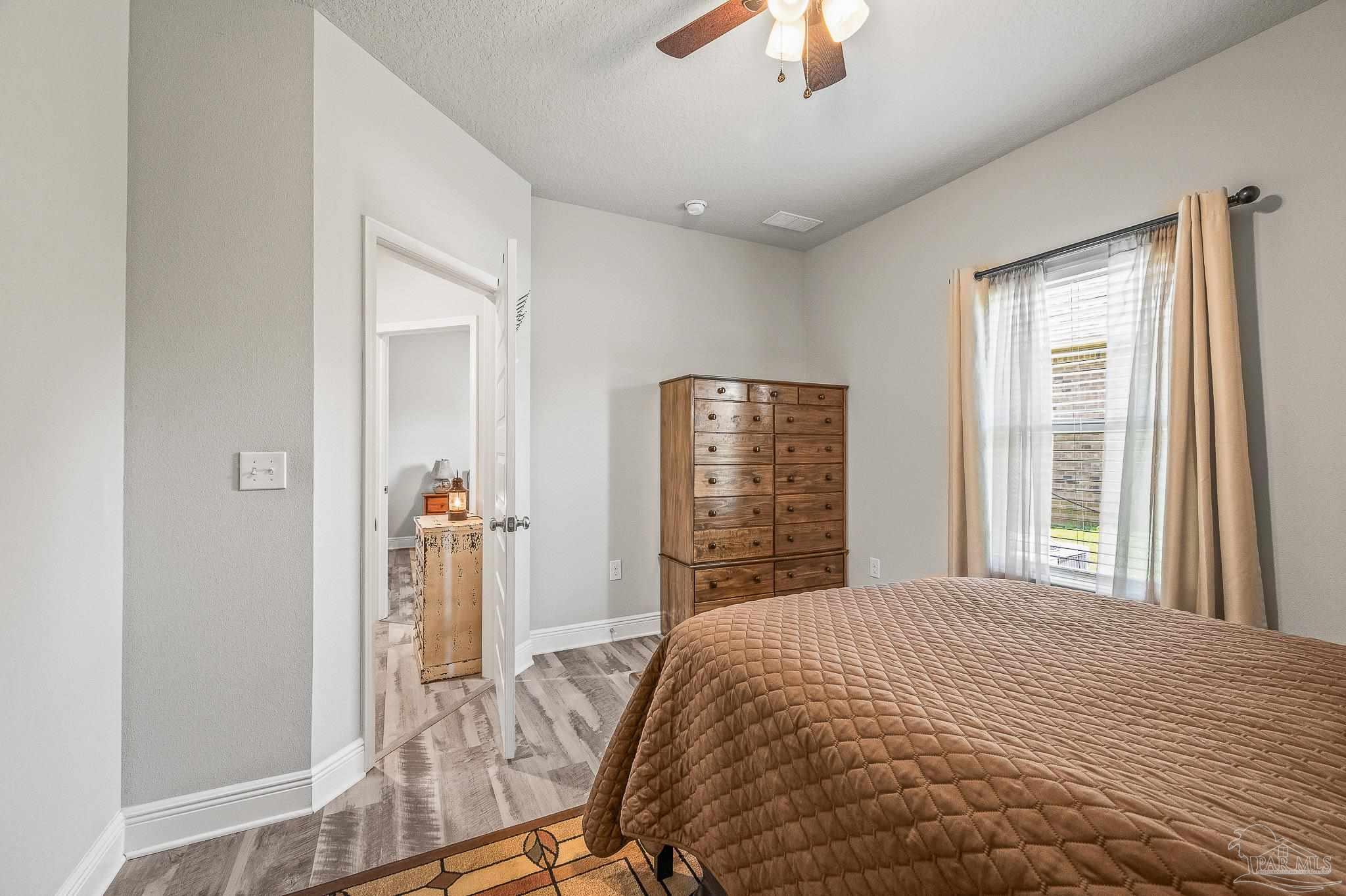 8056 Stream Ridge Road Pensacola, FL 32526 - Photo 15 of 71 a bedroom with a bed and a window