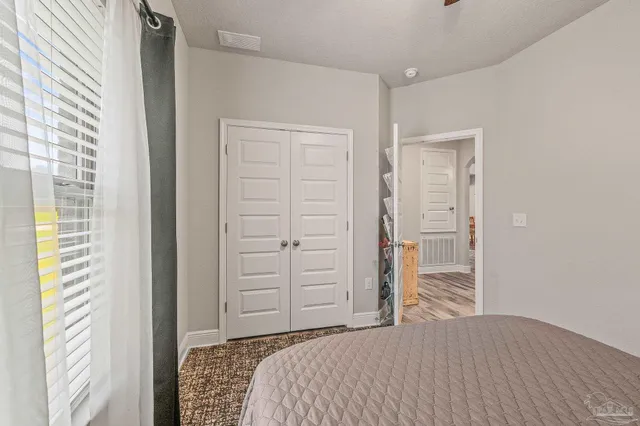 a bathroom with a granite countertop toilet sink and mirror