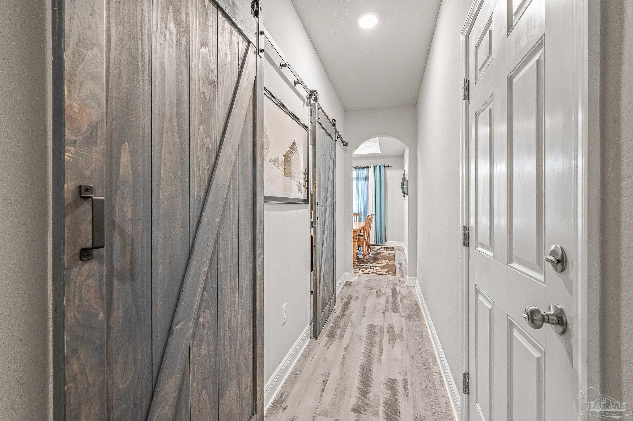 8056 Stream Ridge Road Pensacola, FL 32526 - Photo 22 of 71 a view of a hallway with wooden floor and stairs