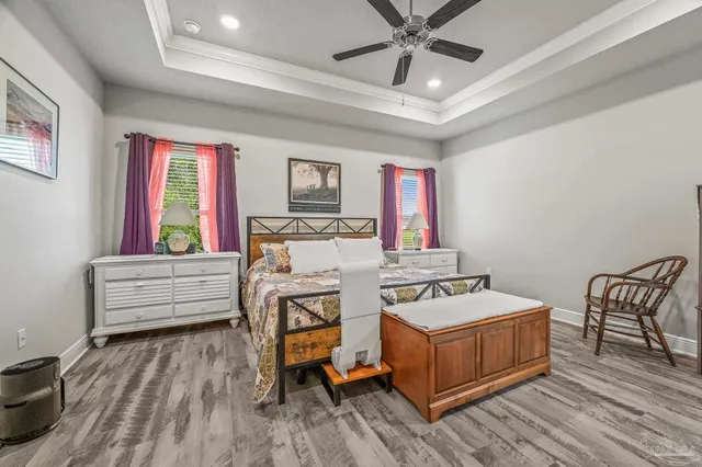 a view of a bedroom with furniture and window