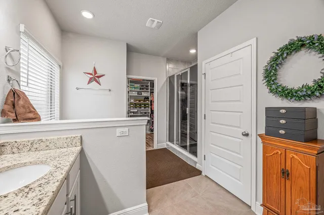 a front view of a house with swimming pool having outdoor seating