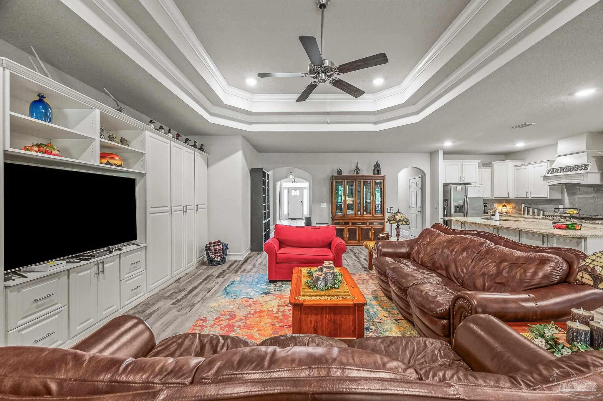 8056 Stream Ridge Road Pensacola, FL 32526 - Photo 38 of 71 a living room with furniture and a flat screen tv