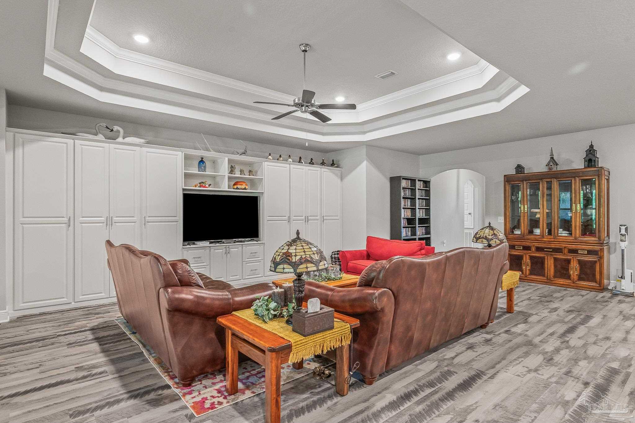8056 Stream Ridge Road Pensacola, FL 32526 - Photo 39 of 71 a living room with furniture and a flat screen tv