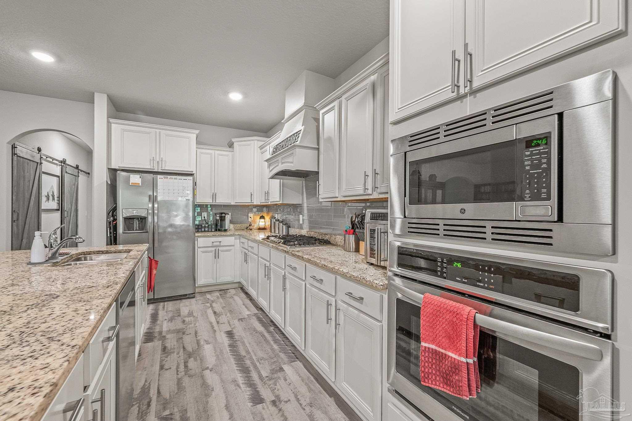 8056 Stream Ridge Road Pensacola, FL 32526 - Photo 43 of 71 a kitchen with stainless steel appliances granite countertop a stove and cabinets
