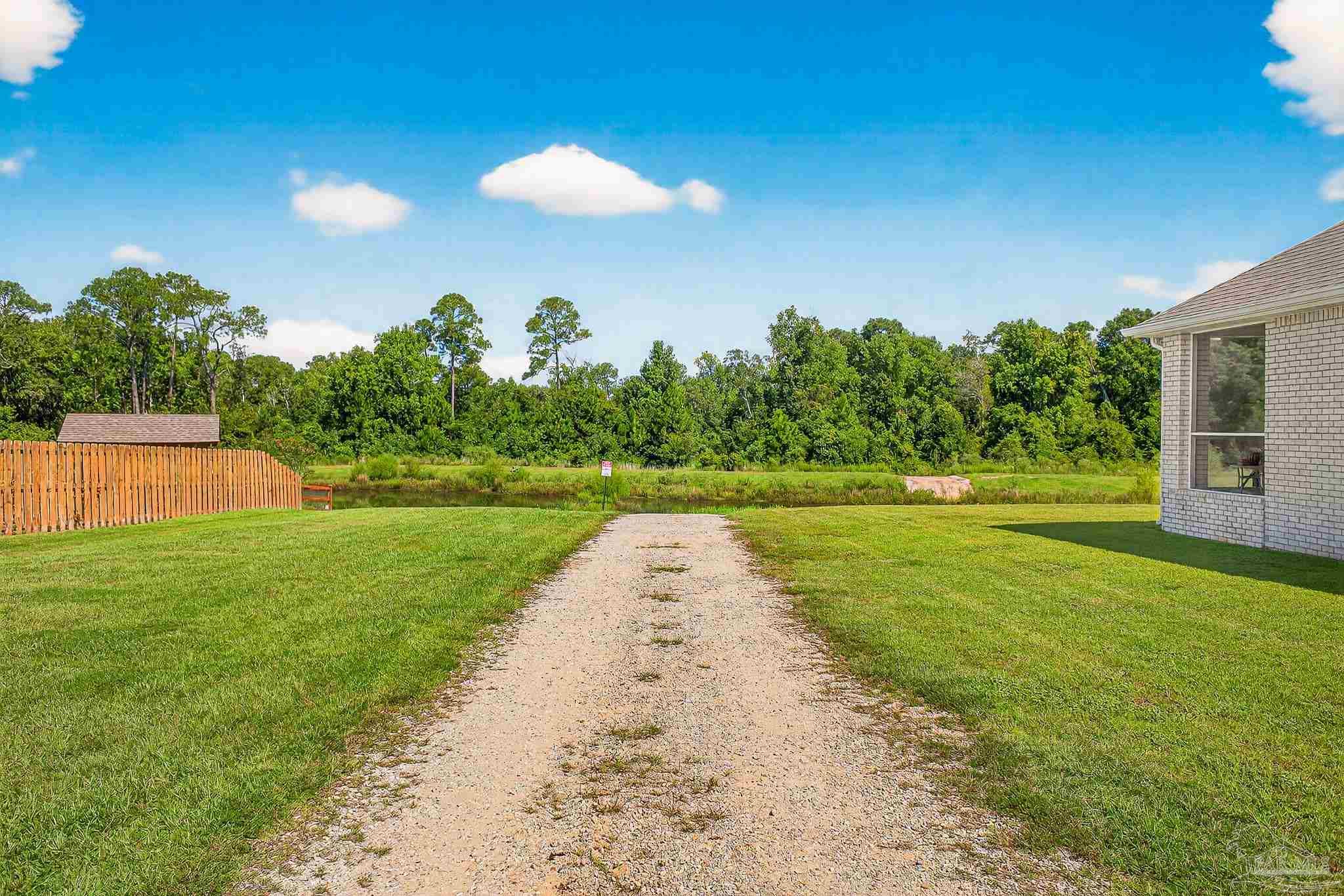 8056 Stream Ridge Road Pensacola, FL 32526 - Photo 66 of 71 a view of a yard with plants and large trees
