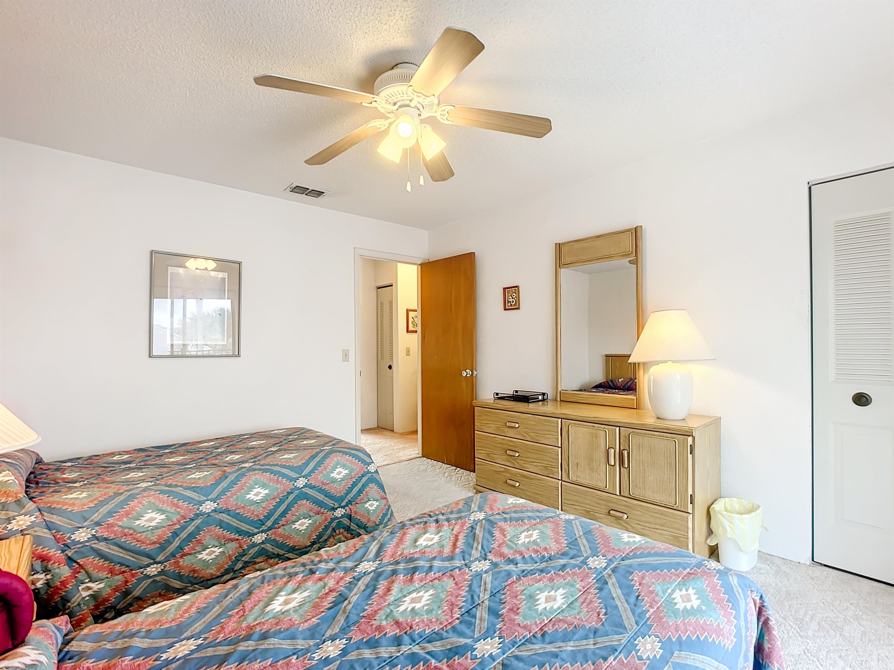 21 Dondanville Road, Unit 20 St. Augustine, FL 32080 - Photo 15 of 33 a bedroom with a bed and a chandelier