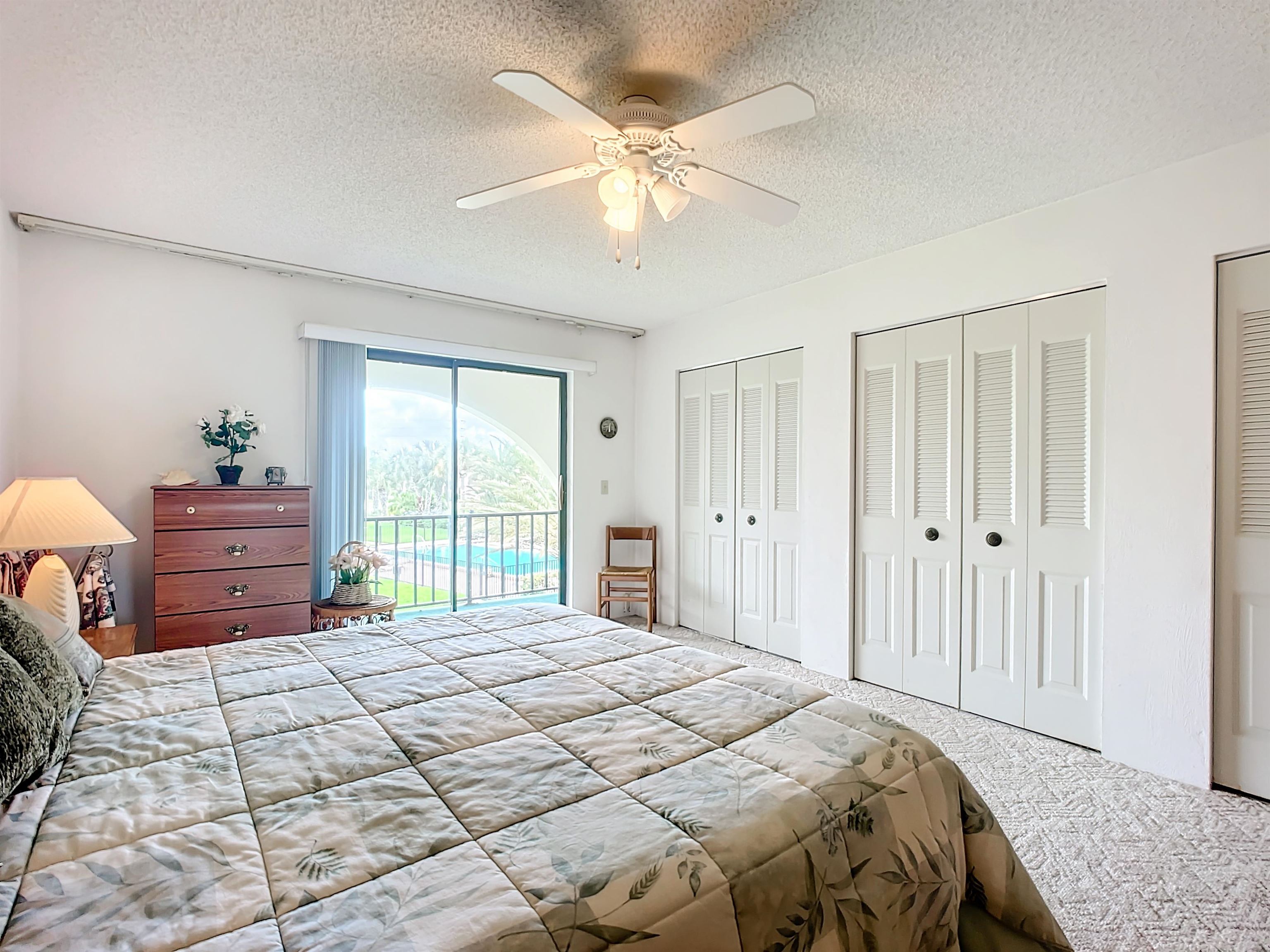 21 Dondanville Road, Unit 20 St. Augustine, FL 32080 - Photo 19 of 33 a bedroom with a large bed and a chandelier
