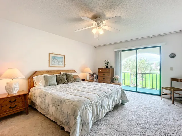 a bedroom with bed and a chandelier