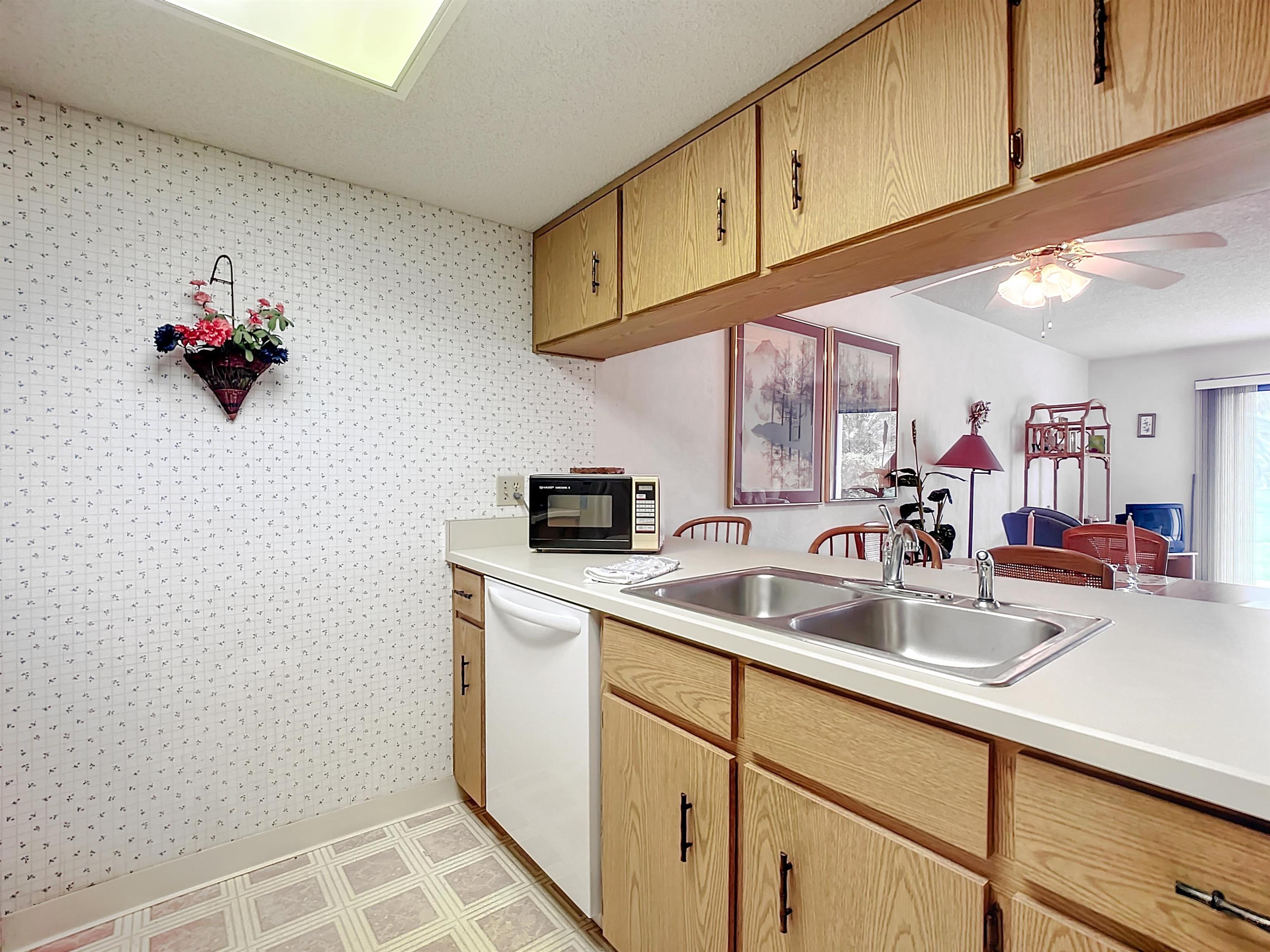 21 Dondanville Road, Unit 20 St. Augustine, FL 32080 - Photo 8 of 33 a kitchen with a sink cabinets and a wooden floor