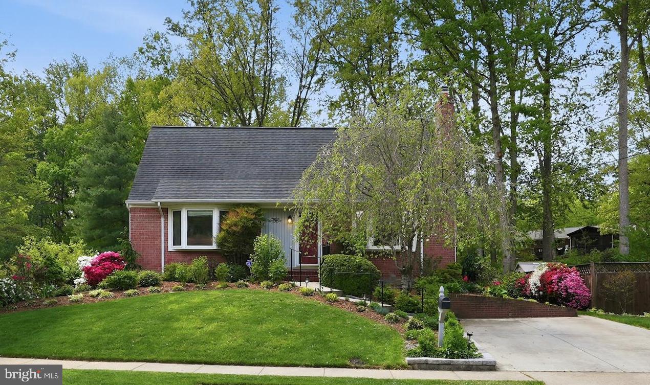 a view of house with outdoor space and garden