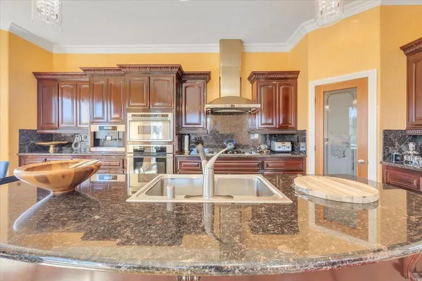 a spacious bathroom with a granite countertop sink and a bathtub
