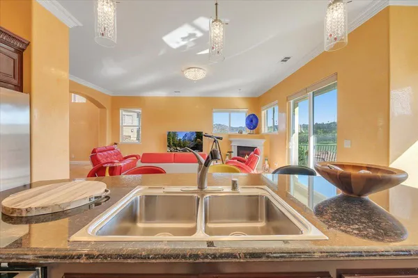 a spacious bedroom with a bed a mirror and a large window