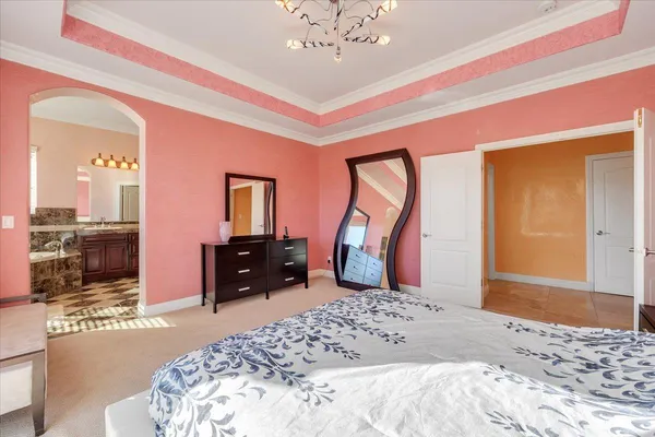a bedroom with a bed and a painting on the wall