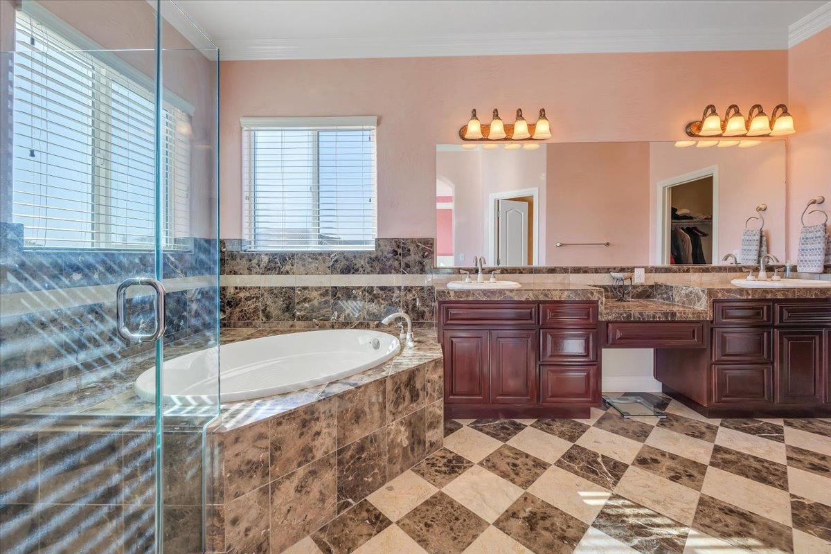 78 Aphrodite Court Copperopolis, CA 95228 - Photo 38 of 98 a spacious bathroom with a granite countertop sink and a bathtub